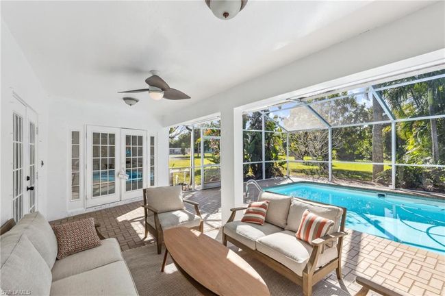 Sunroom featuring an outdoor living space, ceiling fan, french doors, and a swimming pool | Image 8