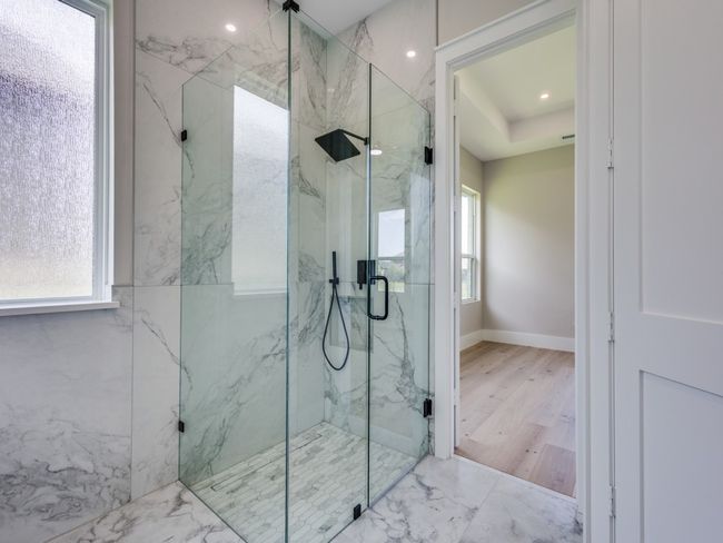 Primary bath, with marble finish shower, marble flooring | Image 33