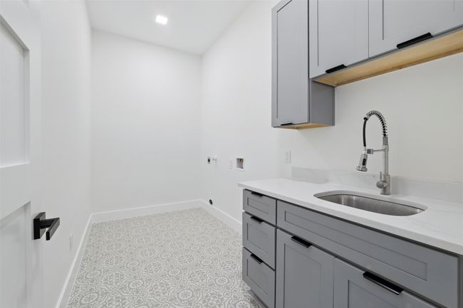 Laundry room with baseboards, cabinet space, a sink, and hookup for a washing machine | Image 18