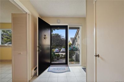 Tiled entry, door from the garage and immediate access to the Eat in Kitchen. | Image 3