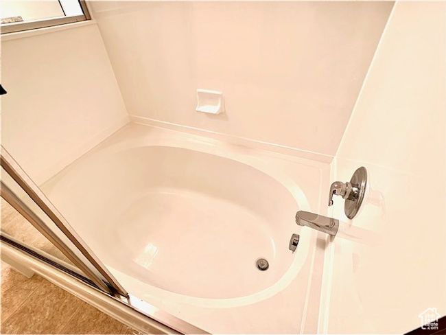 Bathroom view of a tub to relax in | Image 12