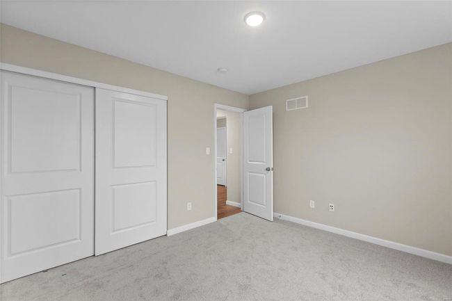 Unfurnished bedroom with light carpet and a closet | Image 21
