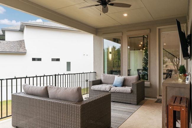 The covered patio features recessed lighting, ceiling fans, and plenty of space for your favorite outdoor decor. | Image 32