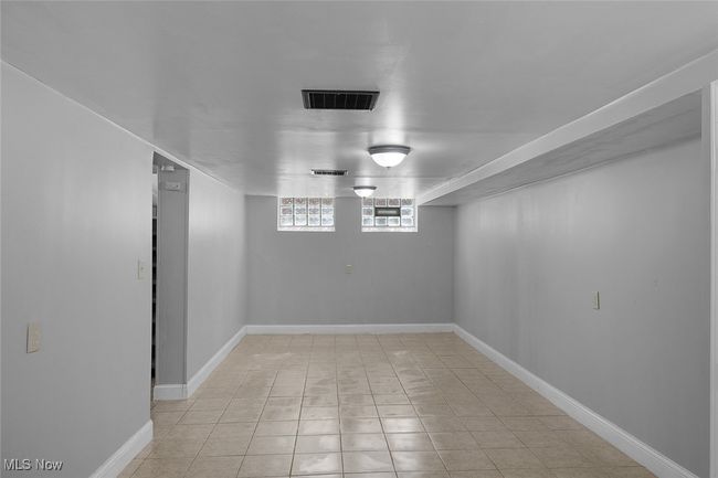 Below grade area with baseboards and visible vents | Image 24
