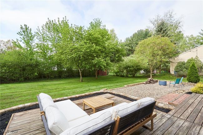 Wooden terrace with outdoor lounge area and a yard | Image 4