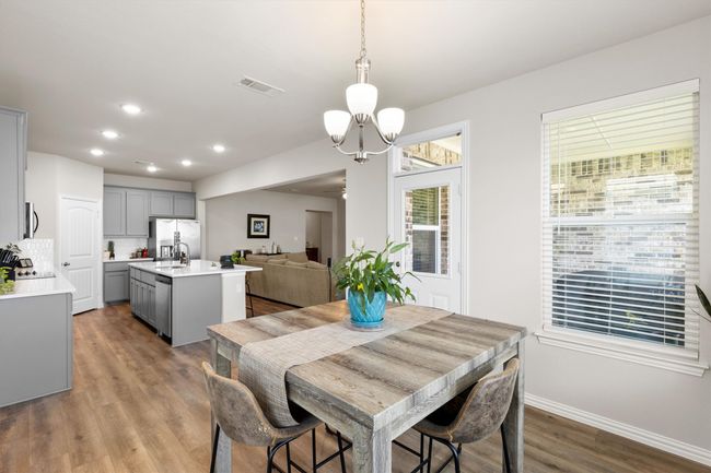 Dining room with a chandelier, wood finished floors, and recessed lighting | Image 13