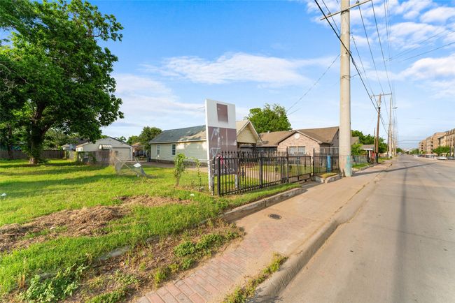 View of asphalt road with a residential view, curbs, and sidewalks | Image 5