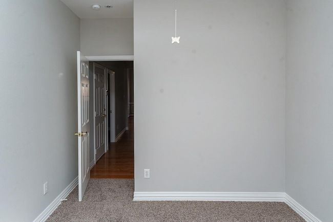 Hallway with carpet floors and baseboards | Image 19