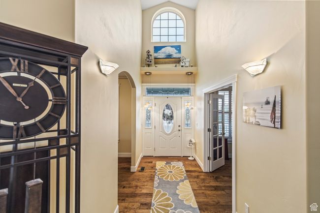 Entrance foyer featuring dark hardwood / wood-style flooring and lofted ceiling | Image 19