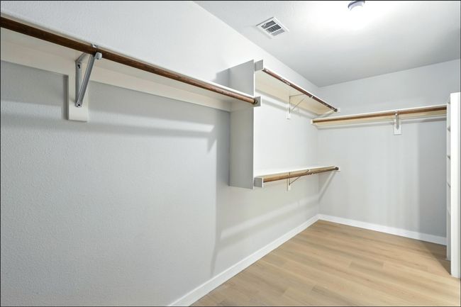 Spacious closet featuring light wood-style floors | Image 35