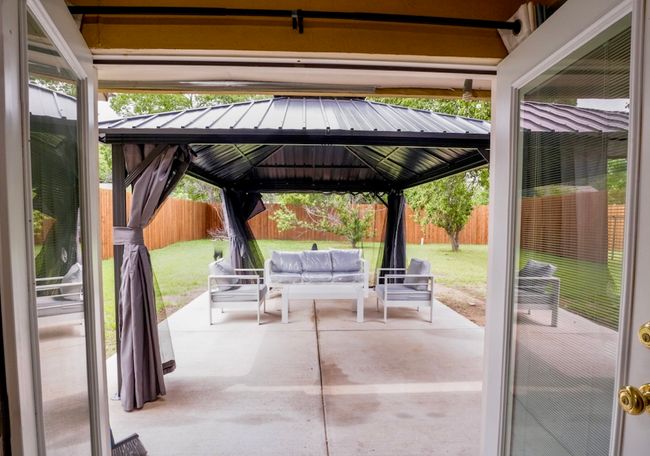 Fenced backyard featuring a gazebo, an outdoor hangout area, and a patio area | Image 20