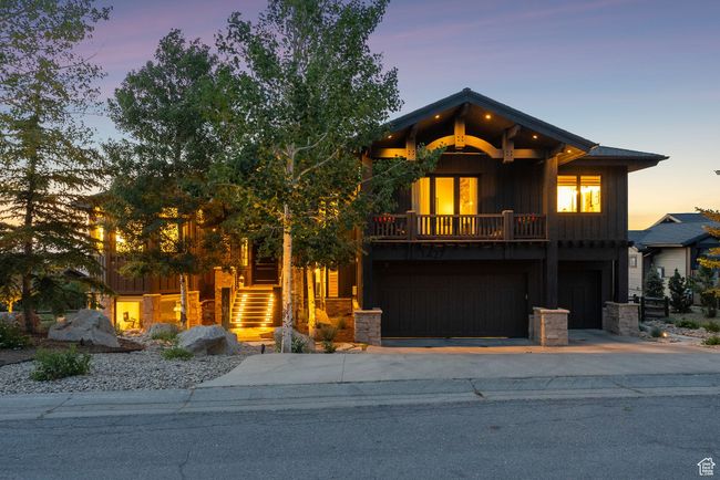 View of front of house featuring board and batten siding, driveway, stairs, and stone siding | Image 10