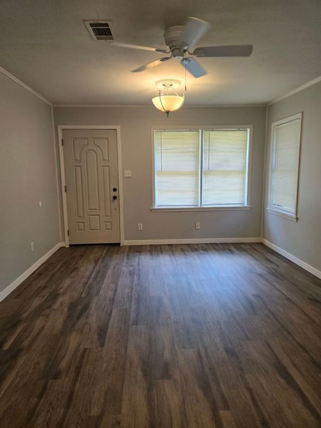 Entrance foyer featuring dark wood-style floors, a ceiling fan, and crown molding | Image 26