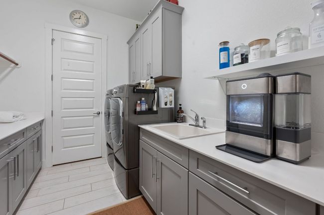 Laundry area featuring separate washer and dryer and cabinet space | Image 33