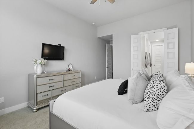 Bedroom with light colored carpet and ceiling fan | Image 13
