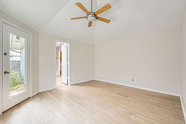 Primary Bedroom featuring lofted ceiling, ceiling fan, and light wood-style Laminate floors | Image 12
