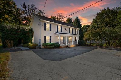 Colonial inspired home with covered porch | Image 1