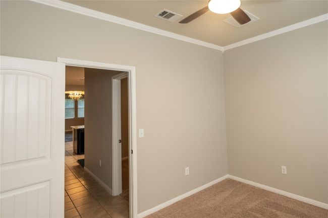Unfurnished room featuring ceiling fan, a chandelier, crown molding, and baseboards | Image 20