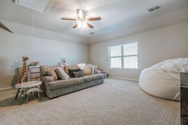 Living room with visible vents, carpet floors, attic access, and baseboards | Image 30