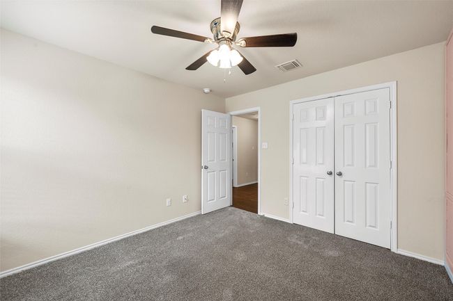 Unfurnished bedroom featuring carpet, a closet, and ceiling fan | Image 27