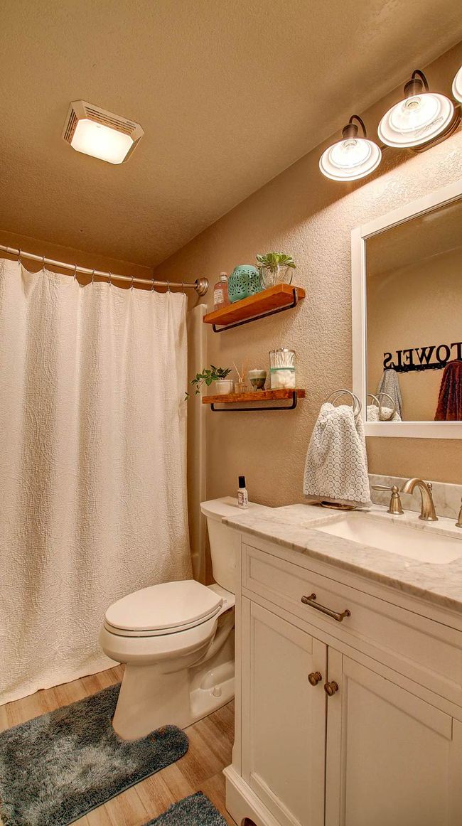 Bathroom with wood finished floors, vanity, and curtained shower | Image 25