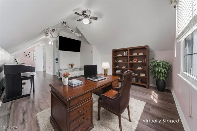 Office space with a ceiling fan, baseboards, vaulted ceiling, and wood finished floors | Image 26
