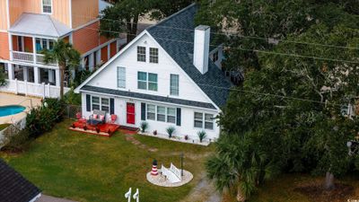 View of front of home featuring a fenced in pool and a front lawn | Image 1