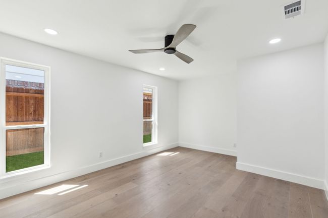 Another large secondary bedroom with sitting area. | Image 24