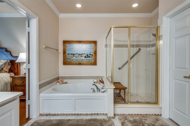 Full bath with a garden tub, a shower stall, crown molding, vanity, and tile patterned floors | Image 19