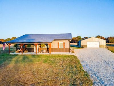 View of front facade with a gazebo, a front yard, a garage, and an outbuilding | Image 3