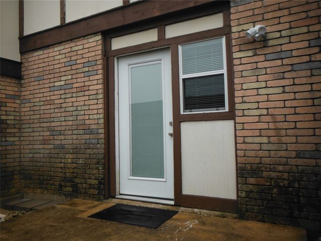 Doorway to property featuring brick siding | Image 23