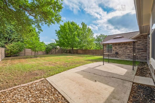 View of yard featuring a patio area, a fenced backyard, and a gazebo | Image 34