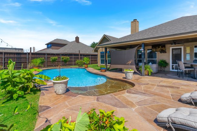 View of pool featuring ceiling fan, a fenced backyard, and a patio area | Image 30