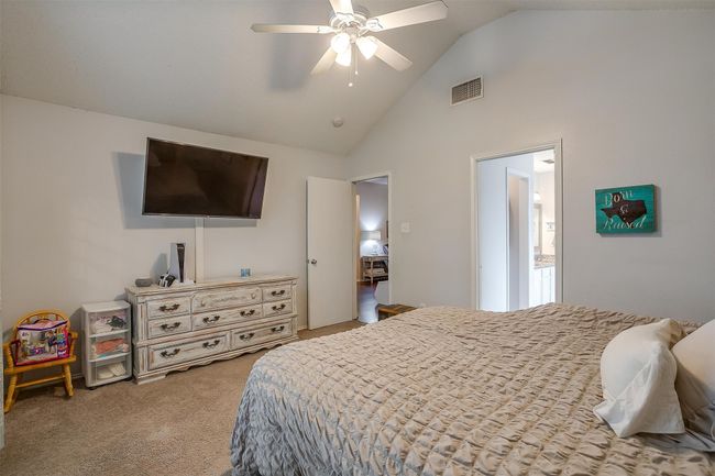 Bedroom featuring carpet flooring, high vaulted ceiling, and ceiling fan | Image 26