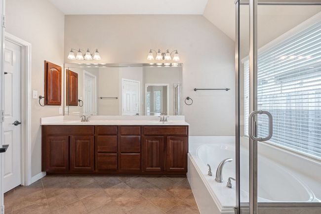Full bathroom featuring double vanity, a garden tub, and shower | Image 14