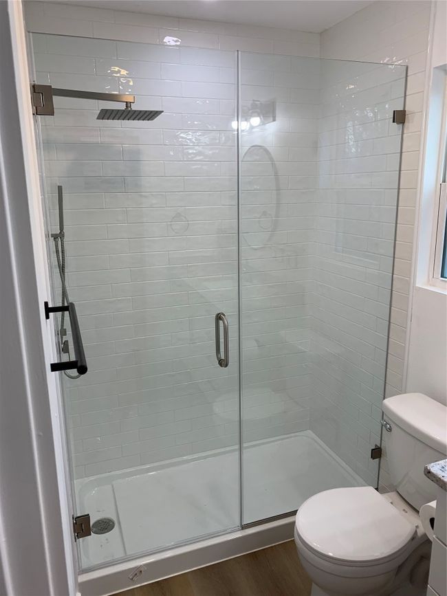 Full bathroom featuring a stall shower and wood finished floors | Image 11