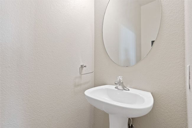 Bathroom with a sink and a textured wall | Image 15