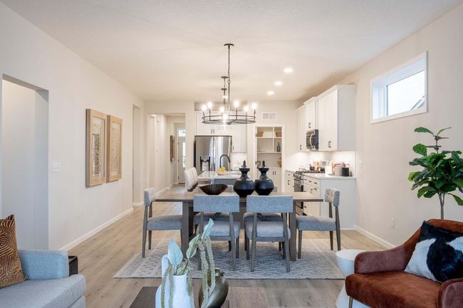 The home boasts a seamless flowing floorplan, connecting living spaces for a cohesive & open feel. This layout enhances both functionality & comfort, perfect for entertaining. Photos are from previously built home; options and features will vary. | Image 11