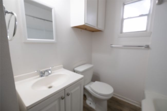 Bathroom with walk in shower, vanity, a bathing tub, toilet, and wood finished floors | Image 11