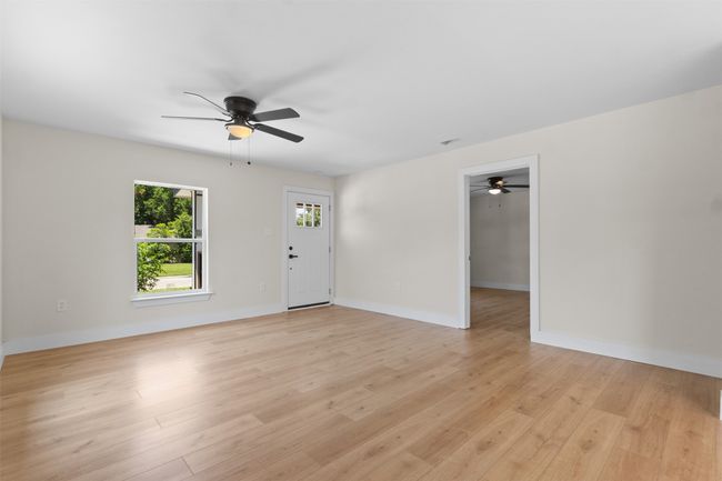 Unfurnished room featuring ceiling fan and light wood finished floors | Image 8
