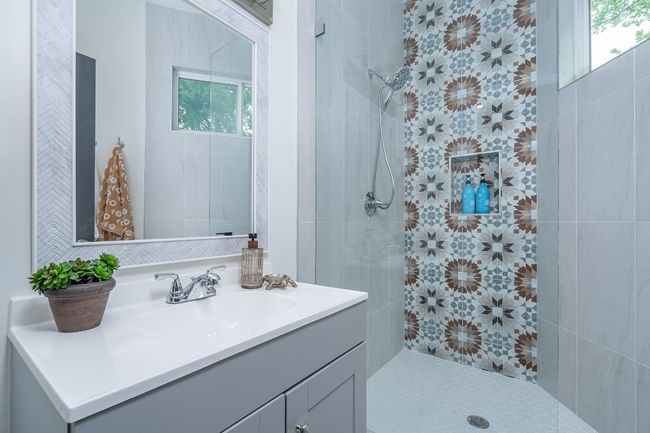 Full bath with a tile shower, a healthy amount of sunlight. | Image 30