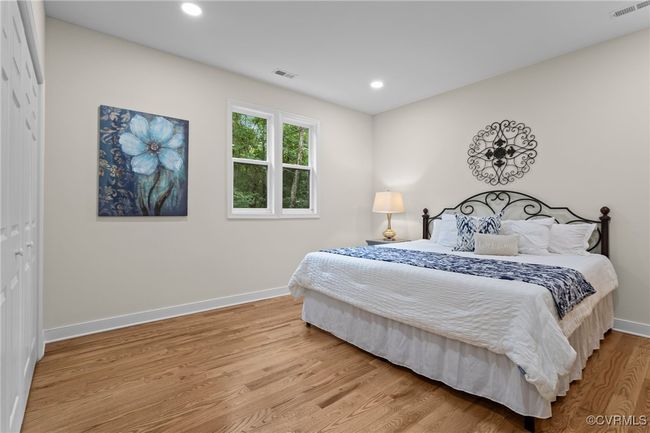 Bedroom with wood finished floors, a closet, and recessed lighting | Image 31