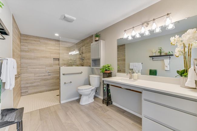The remodeled ensuite bath features a large single vanity, sleek finishes, and a walk-in shower, bringing comfort and style together in one serene space | Image 13