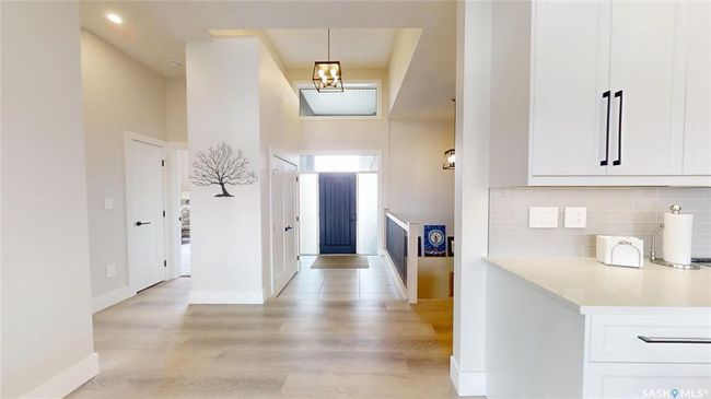 Foyer featuring light wood finished floors and a high ceiling | Image 12