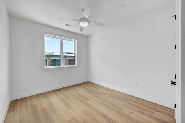 Spare room with a ceiling fan and light wood finished floors | Image 16