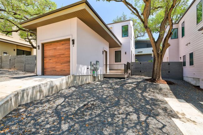 Contemporary home with a gate, an attached garage, and stucco siding | Image 23