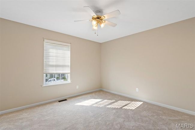 Carpeted spare room with baseboards and a ceiling fan | Image 18