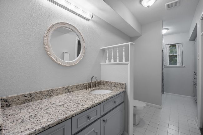 Bathroom with toilet, vanity, and tile patterned flooring | Image 19