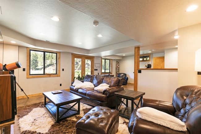 Living room with recessed lighting, a textured ceiling, and plenty of natural light | Image 33