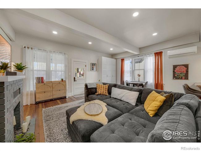 High ceiling and natural light make the living room very inviting. | Image 6